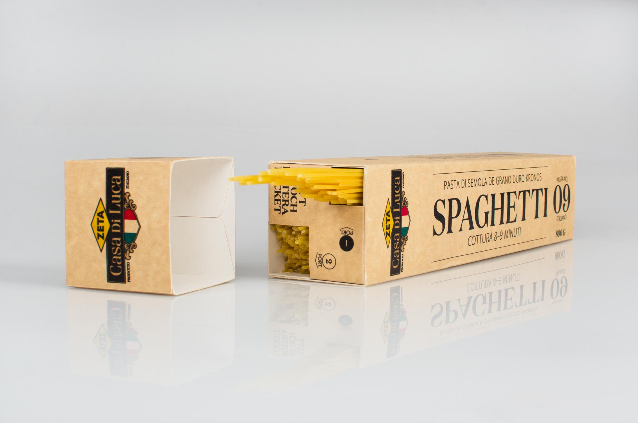 a package of spaghetti lying down with noodles sticking out from the built-in portioning lid